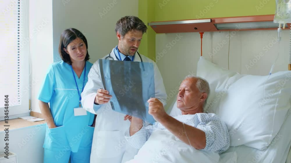 Doctor discussing x-ray with patient at the hospital Doctor discussing x-ray with patient at the hospital