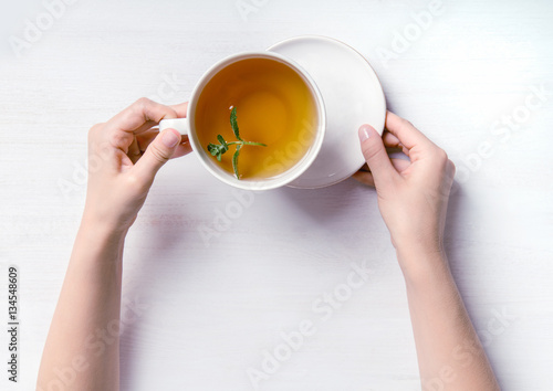 Woman holding cup of tea photo