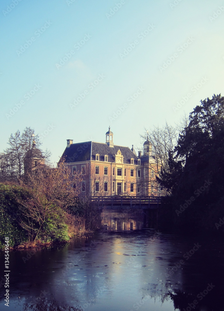 Obraz premium Ancient medieval stone fortress surrounded by water channel, cas