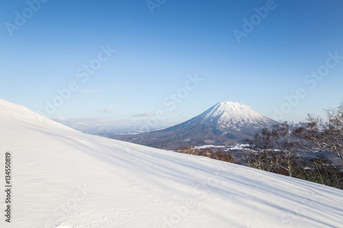 Winter Landscape of Mt.Yotei with snow hill and blue sky at Niseko ski area, Hokkaido, Japan
