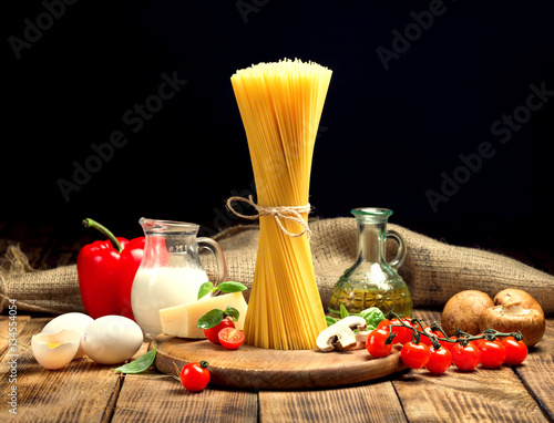 Raw pasta ingredients on wooden table close up