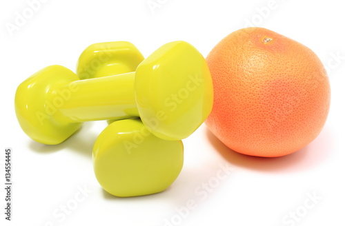 Dumbbells for using in fitness and fresh fruit