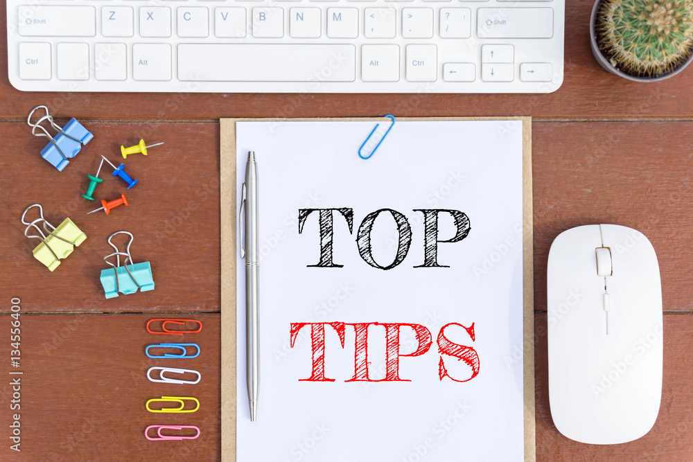 Text Top tips on white paper which has keyboard mouse pen and office ...