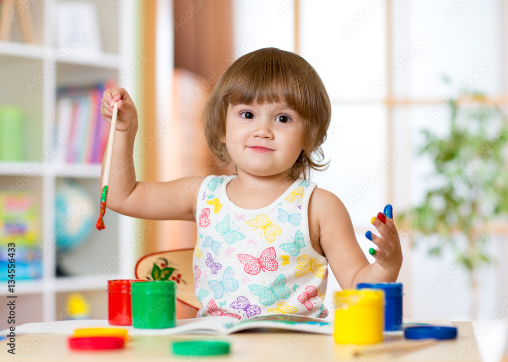 cute cheerful child girl with fingers painted in bright colors cute cheerful child girl with fingers painted in bright colors