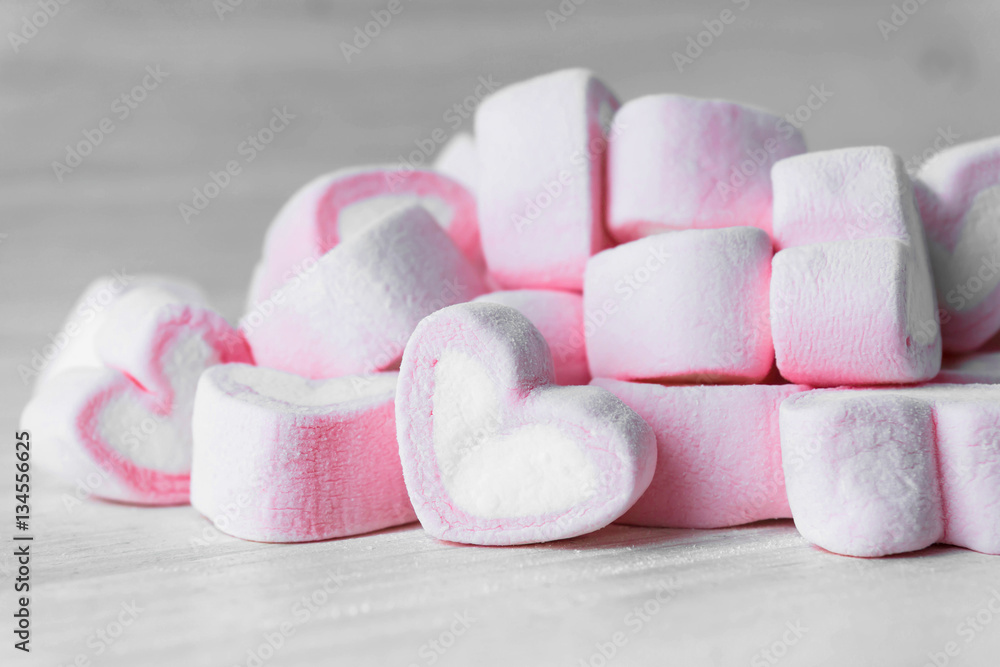 Candy hearts on a white wooden table / heart represents love in Valentine's Day / wedding day.
