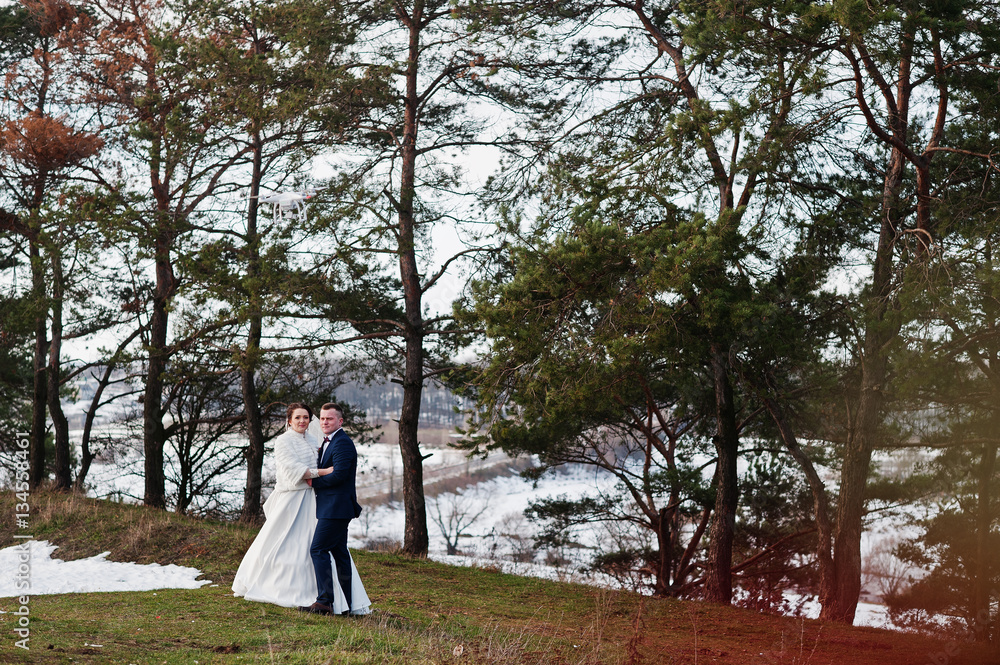 Amazing young wedding couple in love at winter frost and sunny d