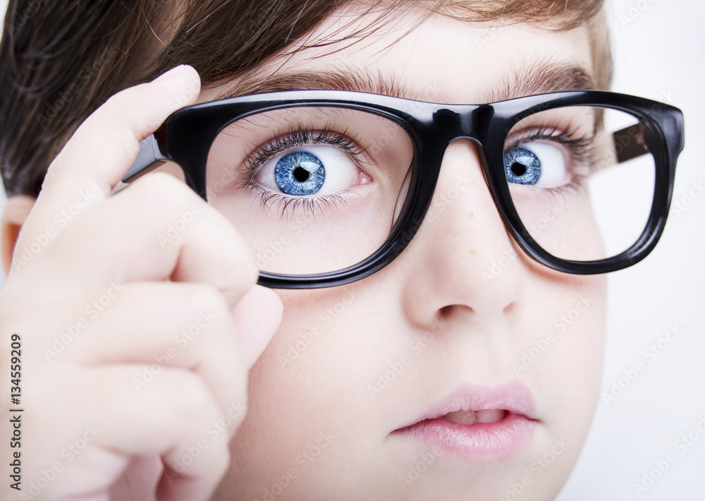 Fototapeta premium Portrait of a boy wearing glasses close, macro studio shot
