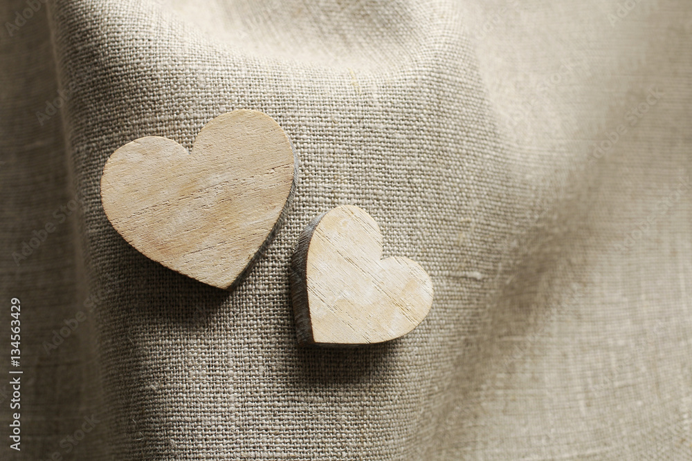 Obraz premium Wooden hearts on linen fabric
