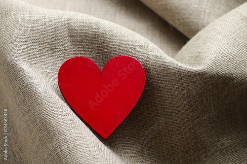 Wooden heart on linen fabric
