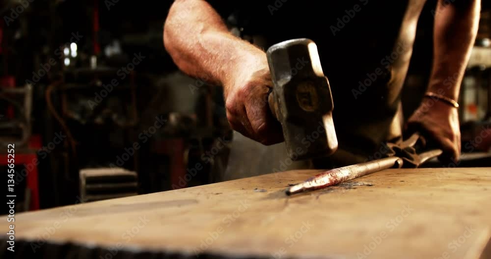 Mid-section of blacksmith working on a iron rod in workshop 4k Mid-section of blacksmith working on a iron rod in workshop 4k