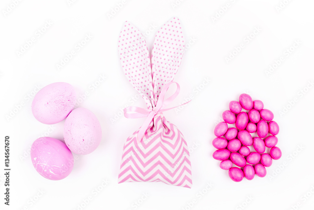 Bunny treat bag with candy and pink eggs. Easter concept Bunny treat bag with candy and pink eggs. Easter concept