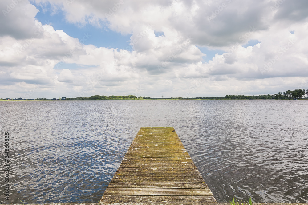 Fototapeta premium Small dock on the lake near the small Dutch town Giethoorn in The Netherlands.