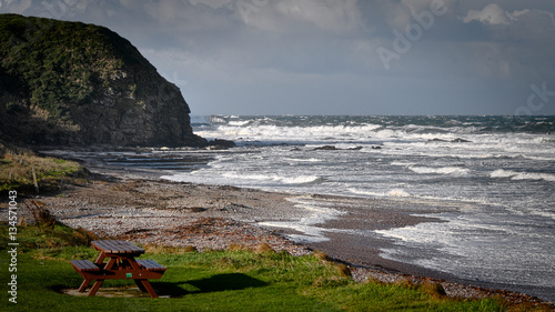 Picnic Table on the Shore and Stormy Sea