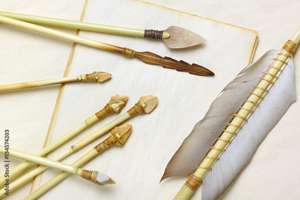 Primitive hunting and fishing arrows with flint stone, wood and bone  arrowheads Stock Photo