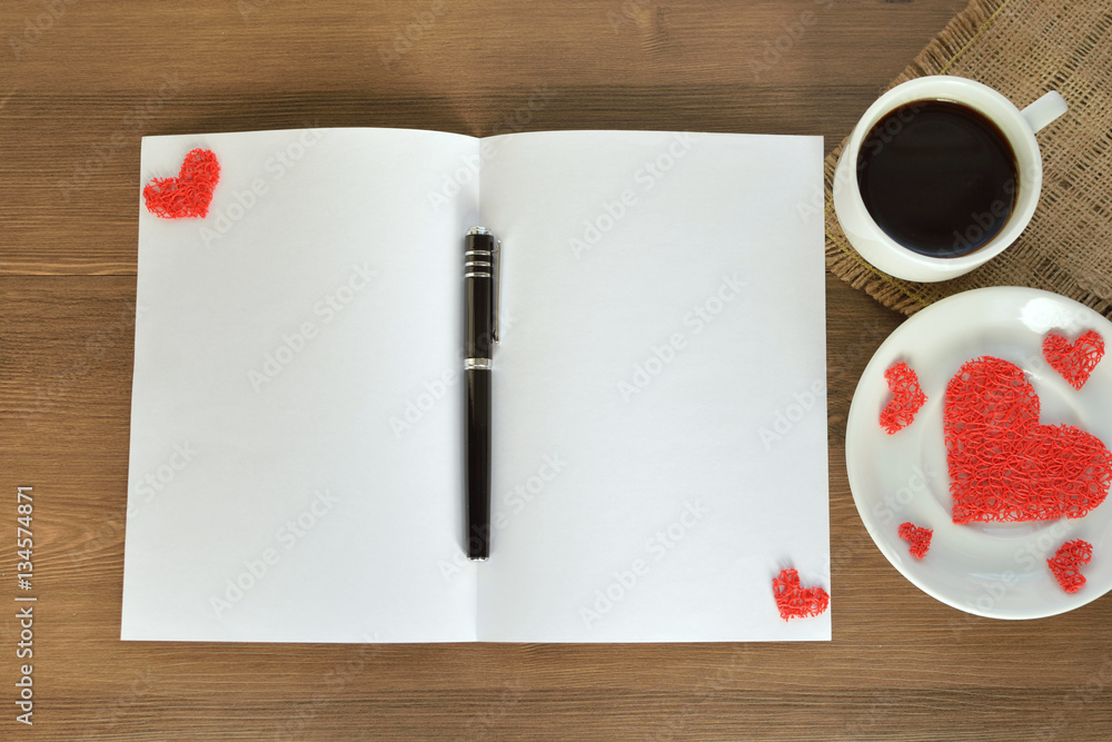 Clean sheet of paper, decorative hearts and coffee mug on wooden background. Valentine's Day. Card for a loved one. Clean sheet of paper, decorative hearts and coffee mug on wooden background. Valentine's Day. Card for a loved one.