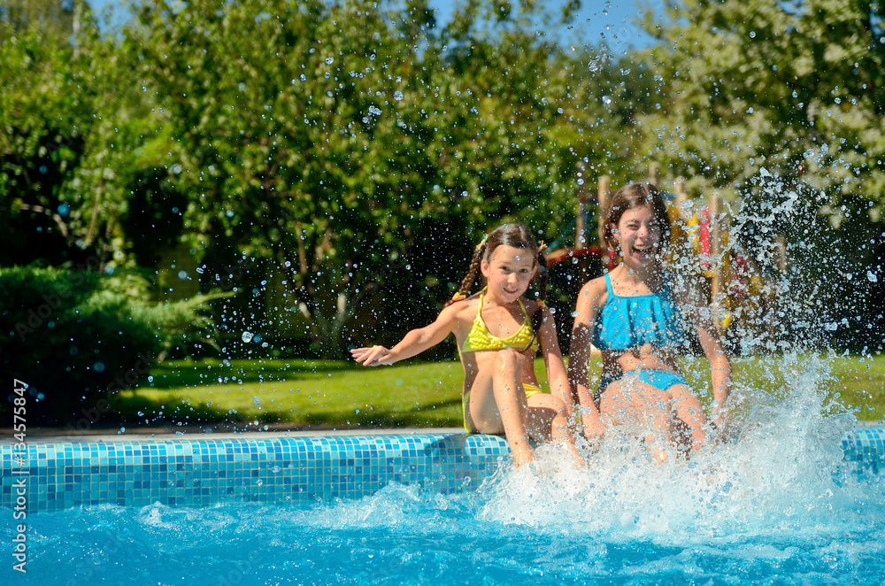 Summer fitness, kids in swimming pool have fun and splash in water, children on family vacation
