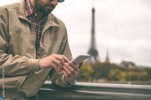 Photography Modern guy using smartphone in the European city.