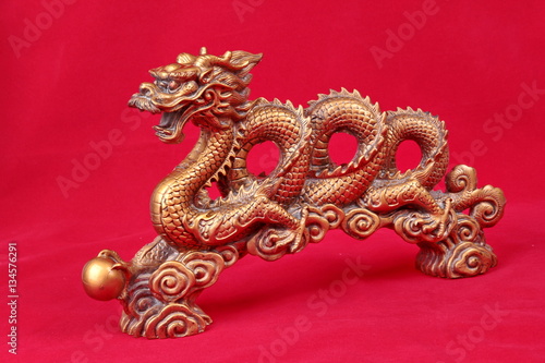 Golden dragon statue on red ,to celebrate for Chinese festival.