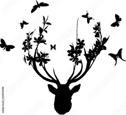 deer black head with blossoming branches between antlers