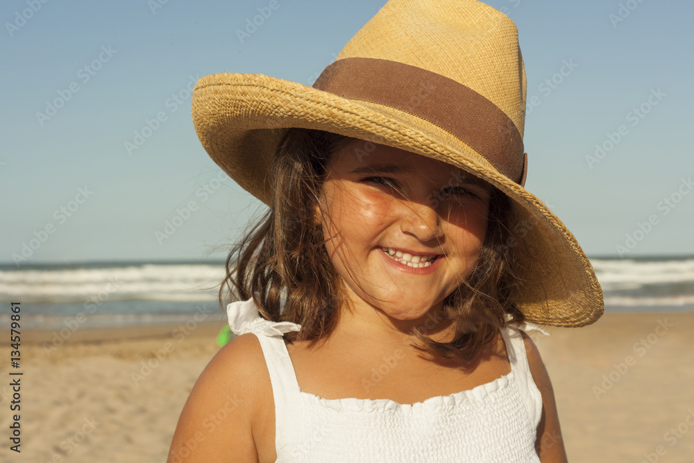 Close up portrait smiling girl wearing wicker hat in summer. Bea