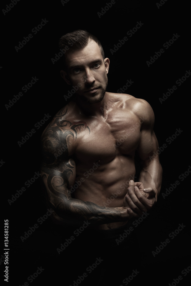 Strong athletic man showes naked muscular body Strong athletic man showes naked muscular body