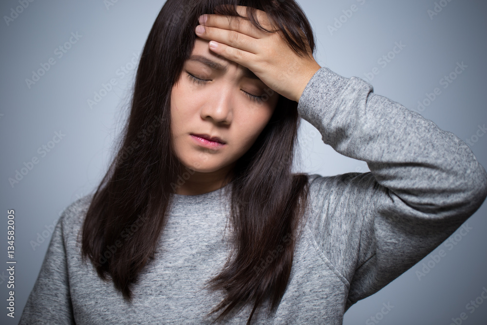 Woman has head ache on isolated background Woman has head ache on isolated background