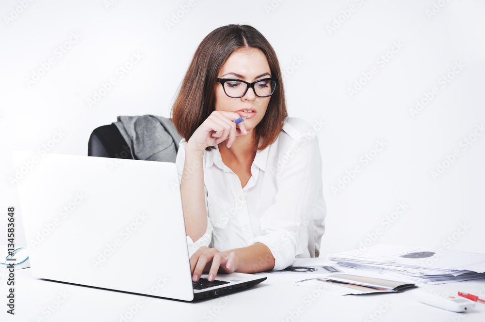 Portrait of beautiful young office woman working with paper at office desk Portrait of beautiful young office woman working with paper at office desk