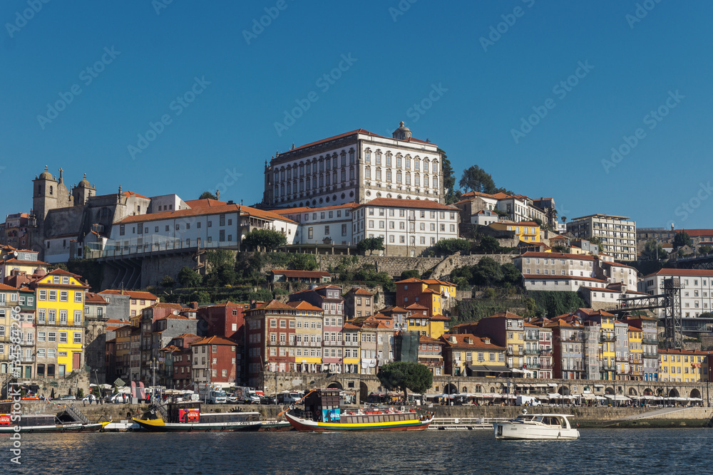 View of the city of Porto with a boat floating on the river Douro