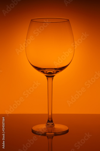 Wine glass on orange background