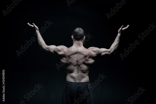 handsome bodybuilder man with muscular body training and posing