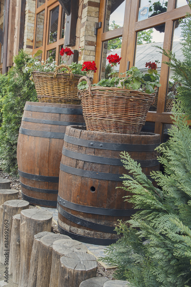 Scenery in the form of barrels and baskets of flowers in a sidew