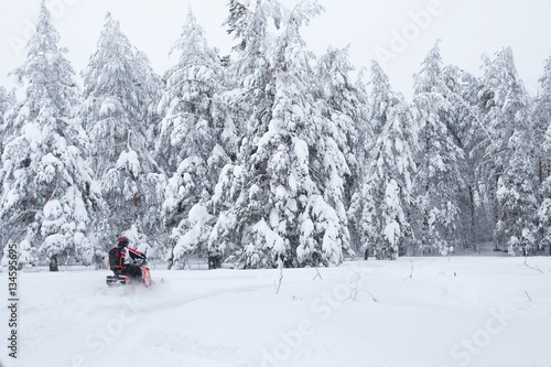 Winter Finnish snowy lanscape with road and snowmobile