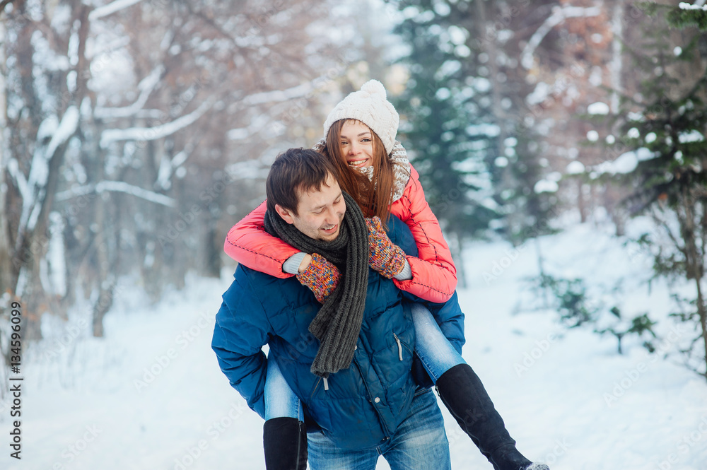 Obraz premium Young couple having fun in the winter forest
