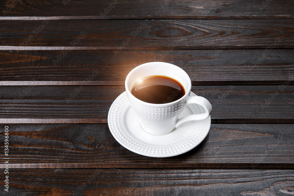 Cup of coffee on a wooden table. Solar flare. Cup of coffee on a wooden table. Solar flare.
