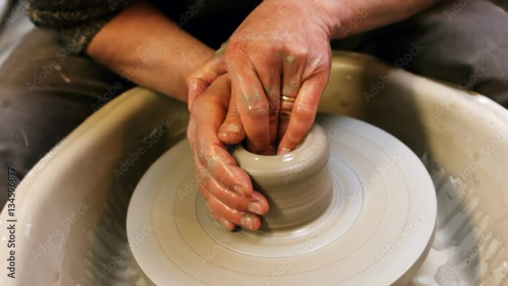 Mid section of potter making pot Mid section of potter making pot