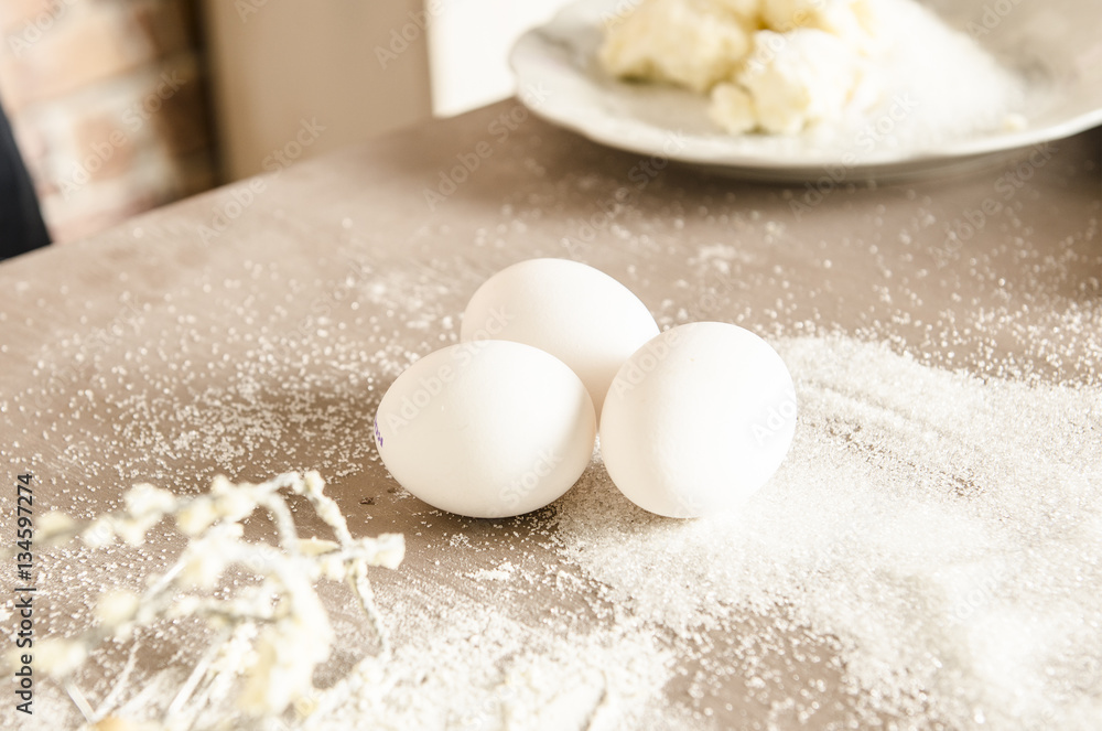 Beautiful picture of white eggs on table with floure in kitchen