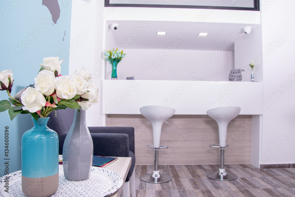 Modern travel agency waiting room. Beautiful modern waiting room. Vase with  flowers and a desk counter in the background. Stock-Foto | Adobe Stock