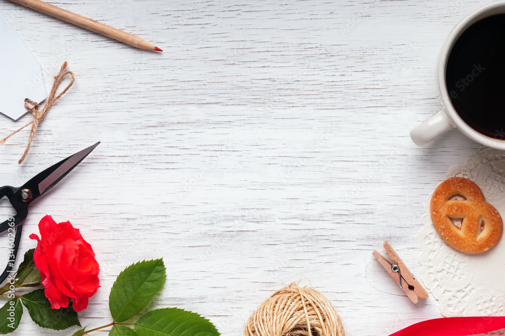 Red rose, coffee, scissors and other small objects on the white Red rose, coffee, scissors and other small objects on the white
