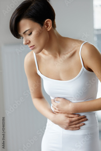Pain In Stomach. Beautiful Woman Feeling Abdominal Pain. Health