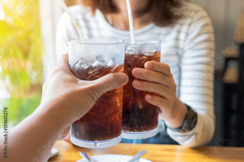 Fotografie Men and Woman hand giving glass of cola.Glass of cola ,Soft drink