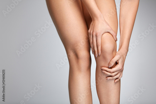 Pain In Knee. Closeup Of Female Leg With Painful Feeling In Knee
