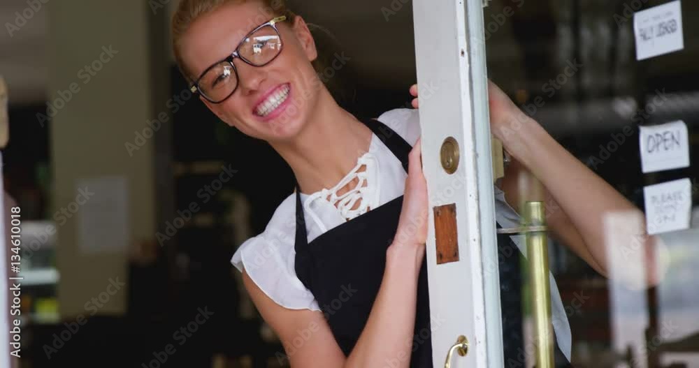Portrait of smiling waitress standing at cafe door 4k Portrait of smiling waitress standing at cafe door 4k