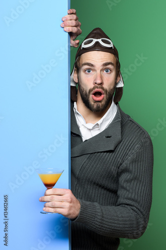 bearded pilot with cocktail in glass