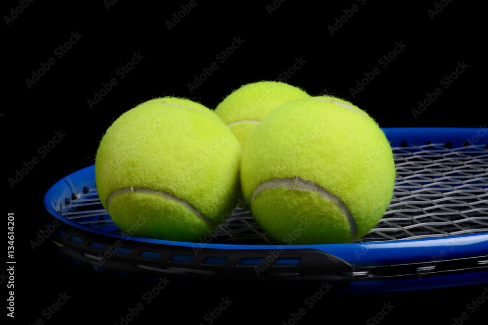 tennis balls and tennis racket black background