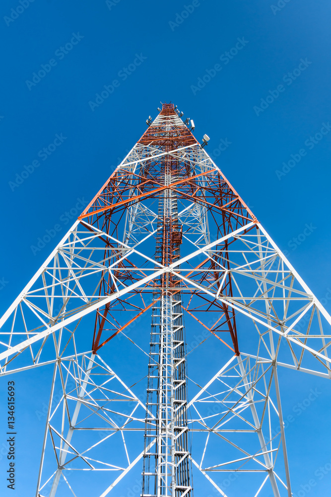  telecomunications tower against clear blue sky.