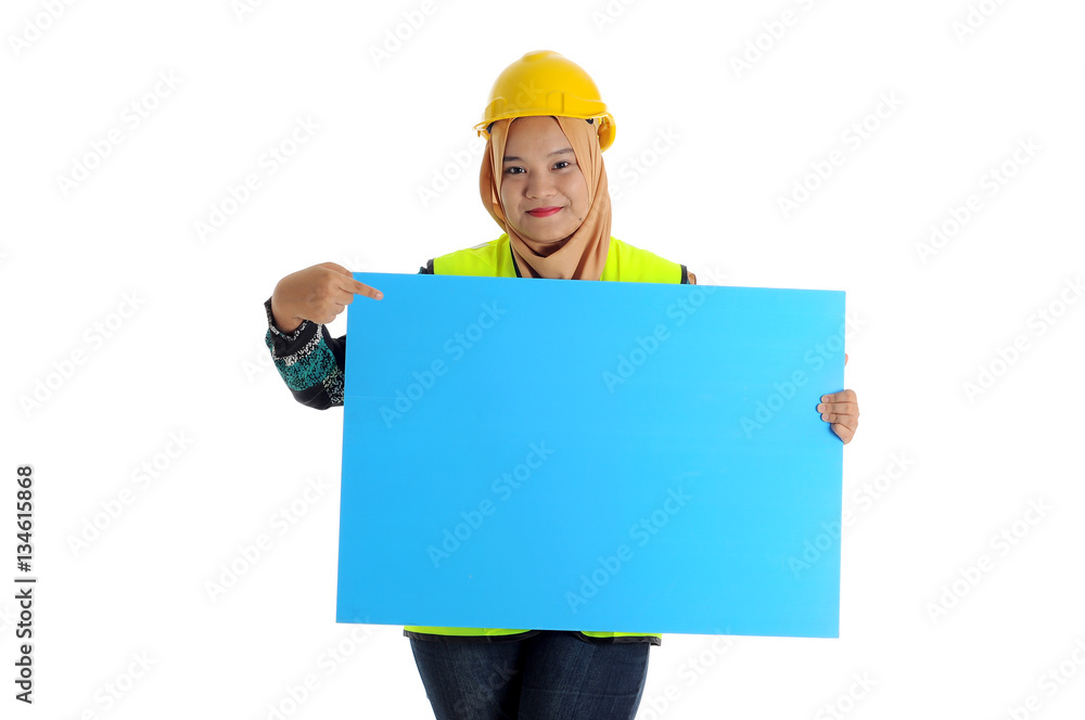 Construction worker wear yellow safety helmet look front and smile while holding text space card. Construction worker wear yellow safety helmet look front and smile while holding text space card.