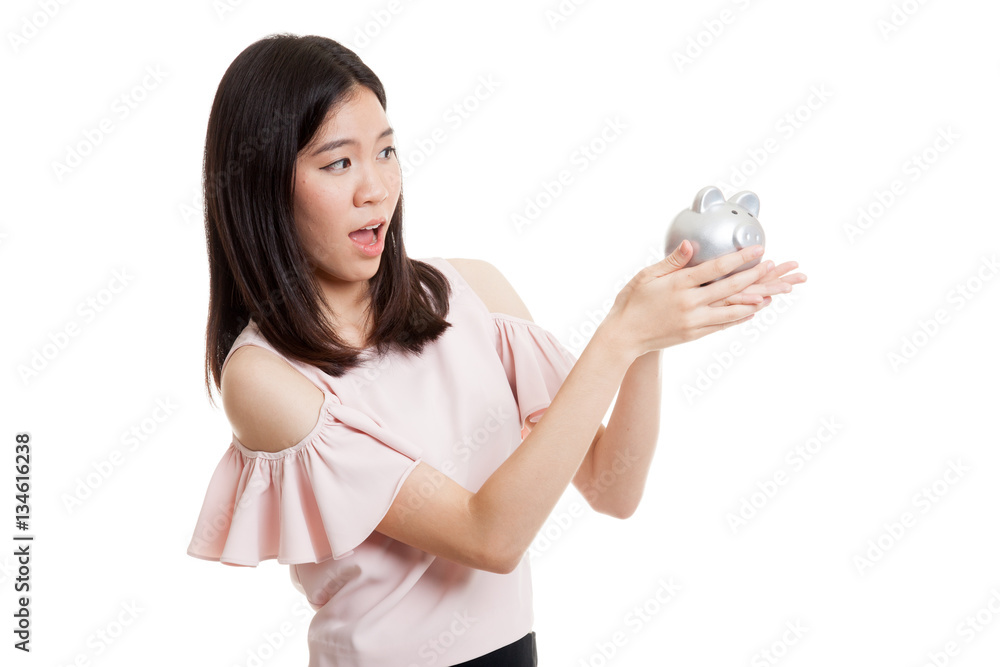 Young Asian business woman with a pig coin bank. Young Asian business woman with a pig coin bank.