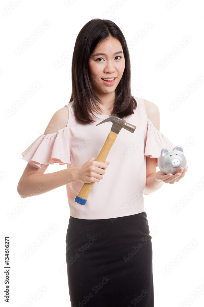 Asian business woman with pig coin bank and hammer. Asian business woman with pig coin bank and hammer.