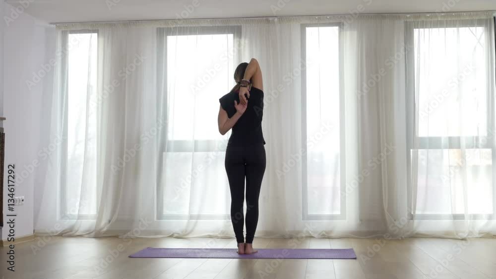 Yogi doing yoga exercise at the gym facing the sunlight in front of the window Yogi doing yoga exercise at the gym facing the sunlight in front of the window