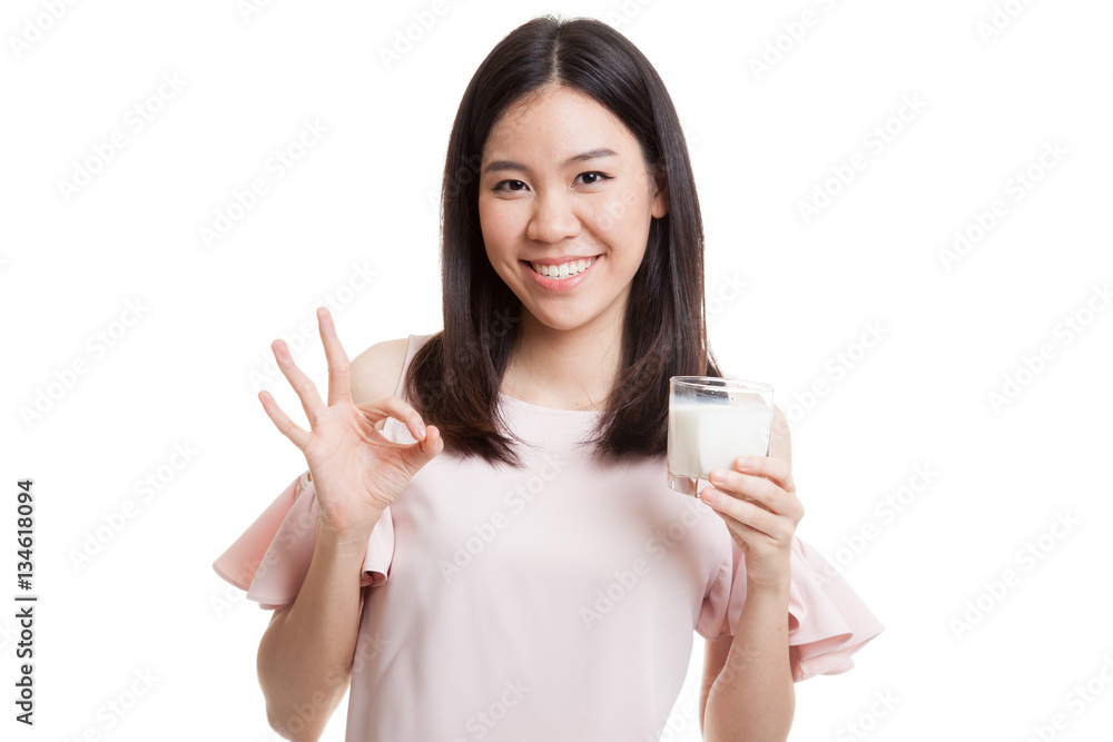 Healthy Asian woman drinking a glass of milk show OK sign. Healthy Asian woman drinking a glass of milk show OK sign.
